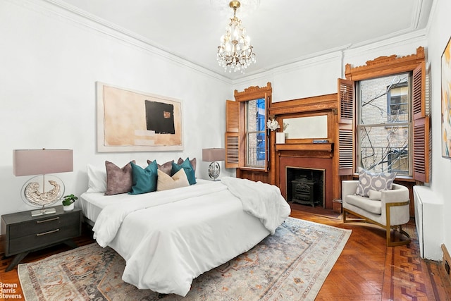 bedroom featuring crown molding, a notable chandelier, and a fireplace