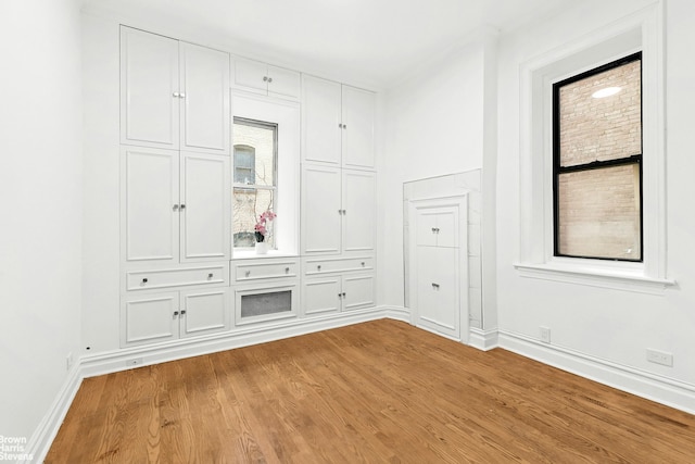 unfurnished room with light wood-style floors and baseboards