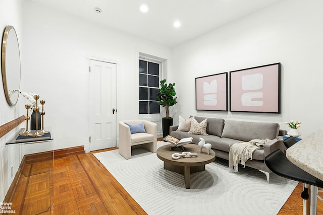 living area featuring baseboards and recessed lighting