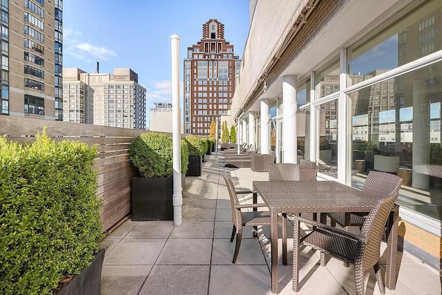 view of patio with a view of city and outdoor dining space