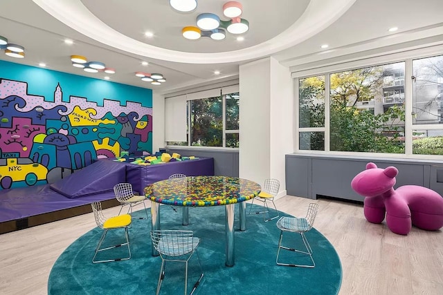 recreation room featuring wood finished floors and recessed lighting