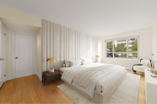 bedroom featuring light wood-style floors and baseboards
