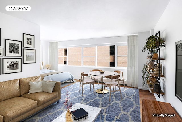 153 E 57th St Unit 11L, New York City, NY 10022 - living room featuring wood finished floors and baseboards