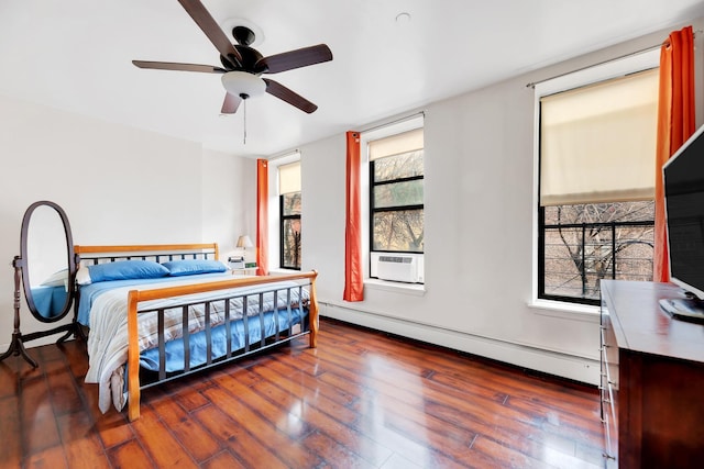 bedroom with a baseboard heating unit, dark wood finished floors, cooling unit, and a ceiling fan