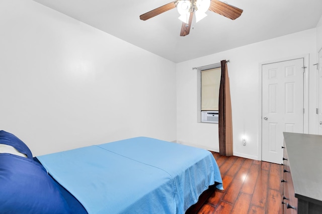 bedroom with dark wood-style floors, baseboards, a ceiling fan, and cooling unit