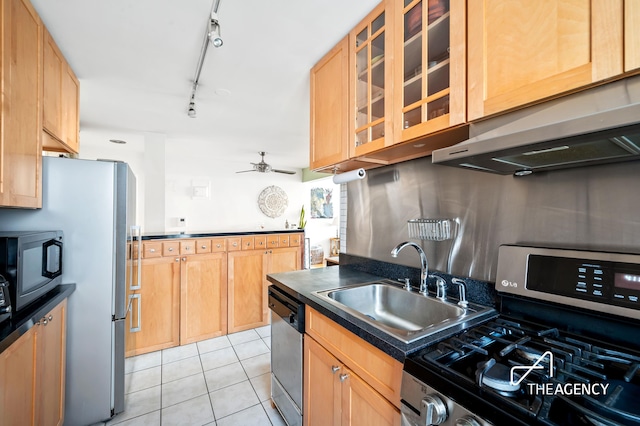 153 Bennett Ave Unit 3G, New York City, NY 10040 - kitchen with stainless steel appliances, a sink, dark countertops, light tile patterned floors, and under cabinet range hood