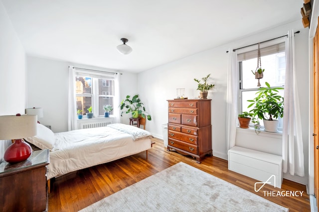 153 Bennett Ave Unit 3G, New York City, NY 10040 - bedroom featuring radiator, wood finished floors, and baseboards