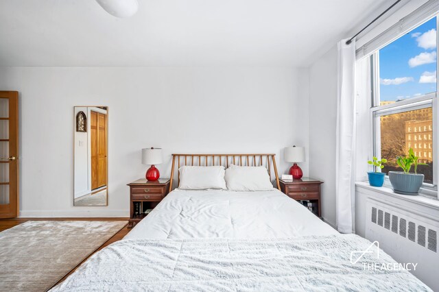 153 Bennett Ave Unit 3G, New York City, NY 10040 - bedroom with radiator heating unit and wood finished floors