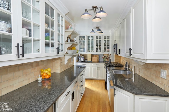 163 E 81st St Unit 6C, New York City, NY 10028 - kitchen with a sink, decorative backsplash, white cabinets, light wood-type flooring, and open shelves