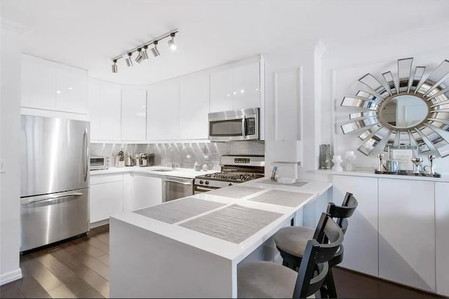 22 W 15th St Unit 8D, New York City, NY 10011 - kitchen with appliances with stainless steel finishes, modern cabinets, tasteful backsplash, and white cabinetry