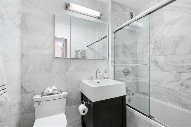 22 W 15th St Unit 8D, New York City, NY 10011 - full bath featuring toilet, combined bath / shower with glass door, tile walls, and vanity