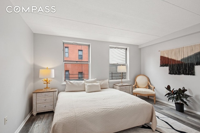 bedroom featuring wood finished floors and baseboards