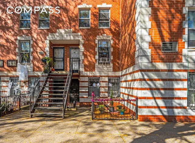view of exterior entry with brick siding