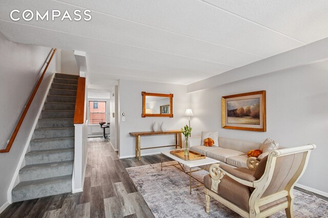2551 Frederick Douglass Blvd Unit 2551D, New York City, NY 10030 - living area featuring stairs, wood finished floors, and baseboards