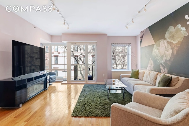 454 W 54th St Unit 3D, New York City, NY 10019 - living room with track lighting and light wood-style flooring