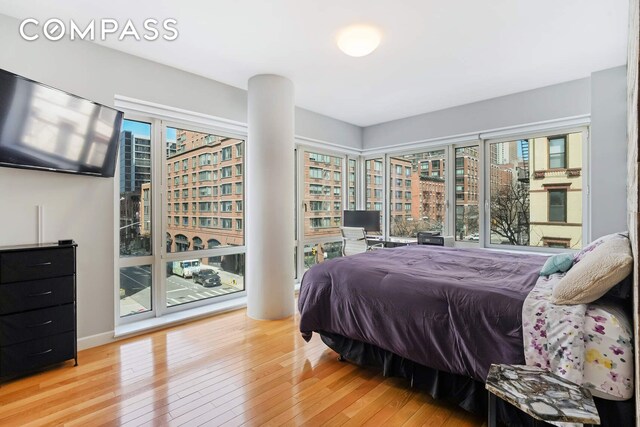 454 W 54th St Unit 3D, New York City, NY 10019 - bedroom featuring hardwood / wood-style floors