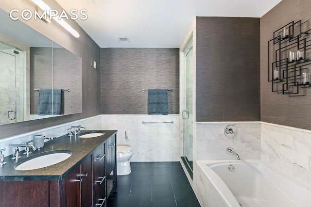 454 W 54th St Unit 3D, New York City, NY 10019 - bathroom featuring tile walls, a garden tub, double vanity, a stall shower, and tile patterned flooring