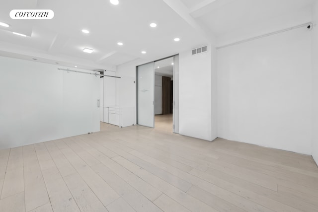 67 Park Ave Unit 1A, New York City, NY 10016 - unfurnished room featuring recessed lighting, light wood-style floors, and a barn door