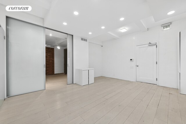 67 Park Ave Unit 1A, New York City, NY 10016 - empty room with beam ceiling, light wood-type flooring, recessed lighting, coffered ceiling, and ceiling fan