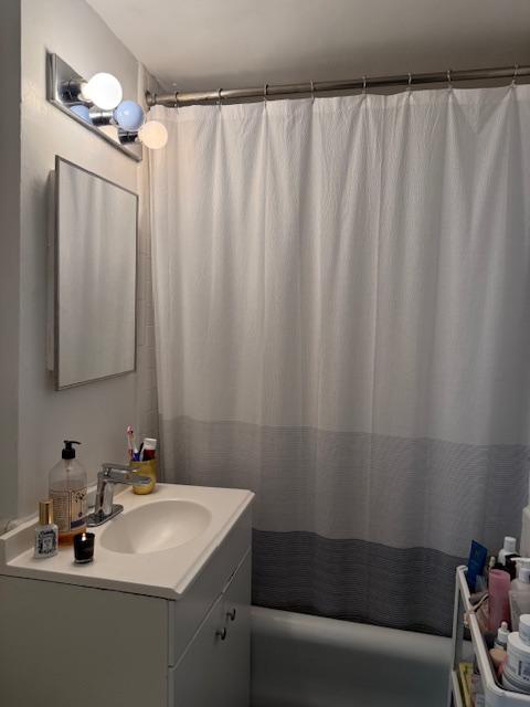 45 Tudor City Pl Unit 1116, New York City, NY 10017 - full bathroom featuring vanity and shower / bathtub combination with curtain