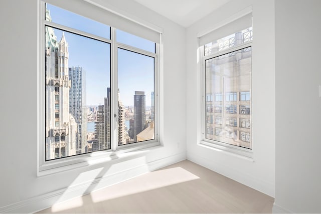 unfurnished room featuring a view of city