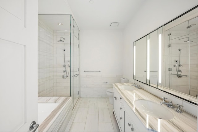 full bath with double vanity, toilet, a sink, and a stall shower
