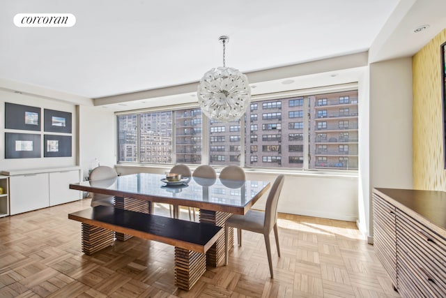 dining area featuring visible vents, a chandelier, and baseboards