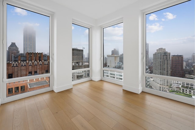 15 W 61st St Unit 27C, New York City, NY 10023 - unfurnished room with a view of skyline and wood finished floors