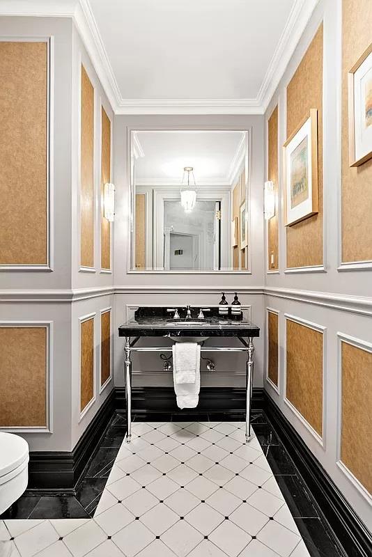 390 W End Ave Unit 6A, New York City, NY 10024 - bathroom featuring toilet, a decorative wall, ornamental molding, and tile patterned floors