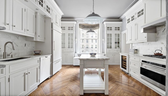 390 W End Ave Unit 6A, New York City, NY 10024 - kitchen with stainless steel appliances, a sink, wine cooler, white cabinetry, and backsplash