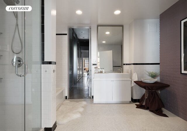 bathroom with recessed lighting, vanity, a bath, and a shower stall