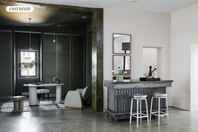 interior space featuring concrete flooring, visible vents, and a bar