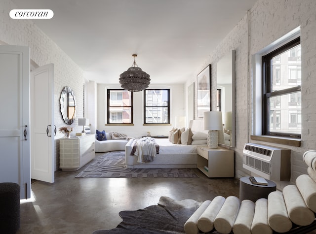 bedroom with visible vents, concrete flooring, multiple windows, and an inviting chandelier