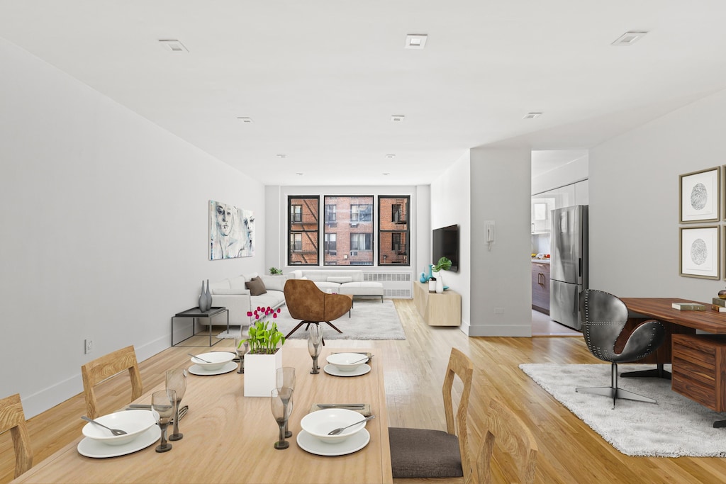 415 Beverley Rd Unit 3H, New York City, NY 11218 - dining area featuring baseboards, light wood-type flooring, and radiator