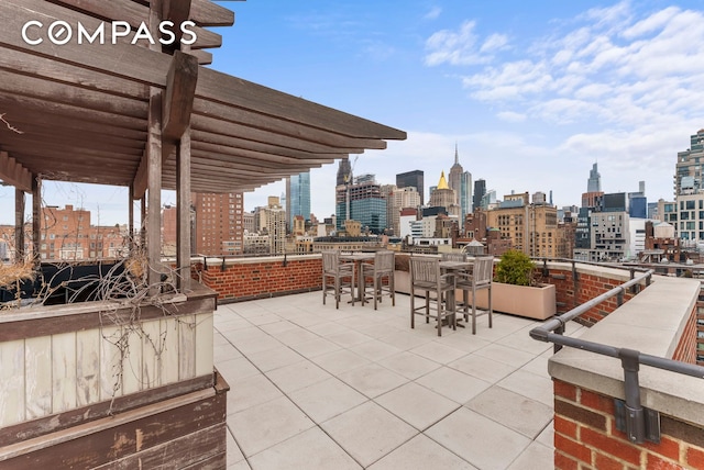 view of patio featuring a view of city and a pergola