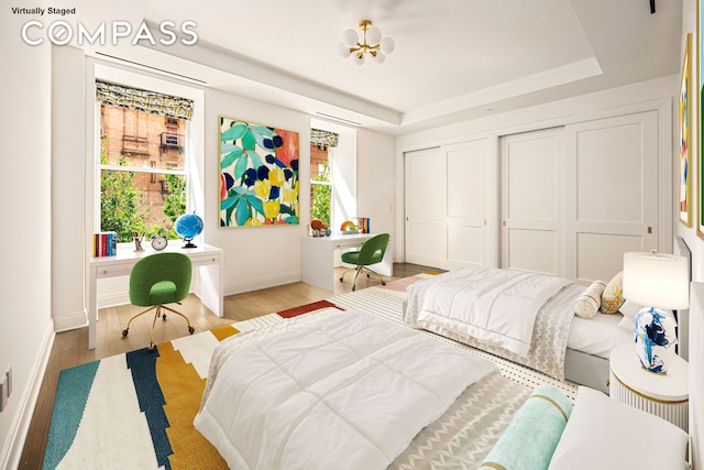 101 W 78th St Unit 3A, New York City, NY 10024 - bedroom with a raised ceiling, baseboards, wood finished floors, and multiple closets
