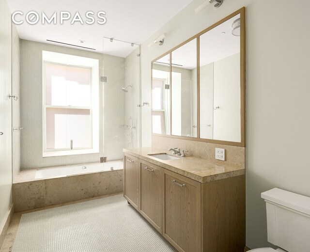 101 W 78th St Unit 3A, New York City, NY 10024 - bathroom featuring vanity, toilet, and a combined bath / shower with marble appearance