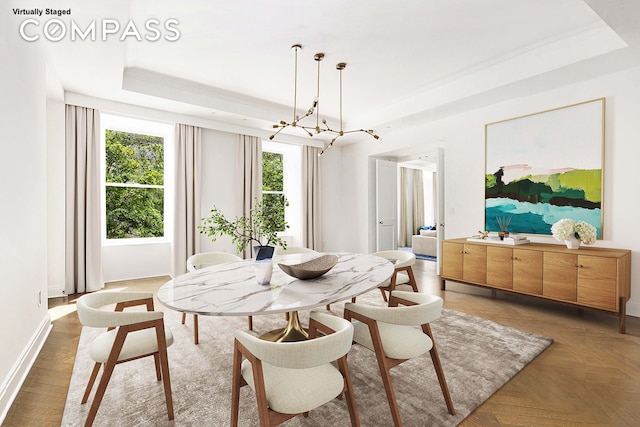 101 W 78th St Unit 3A, New York City, NY 10024 - dining area with a raised ceiling, ornamental molding, a chandelier, and baseboards