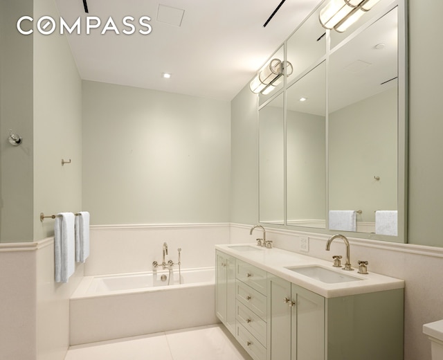 101 W 78th St Unit 3A, New York City, NY 10024 - bathroom featuring a garden tub, double vanity, toilet, and tile patterned flooring