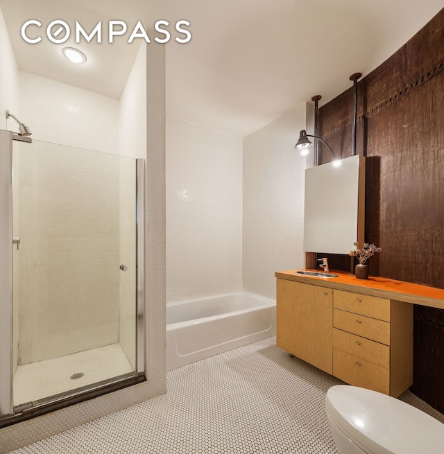 bathroom with an enclosed shower, vanity, a bathing tub, and toilet