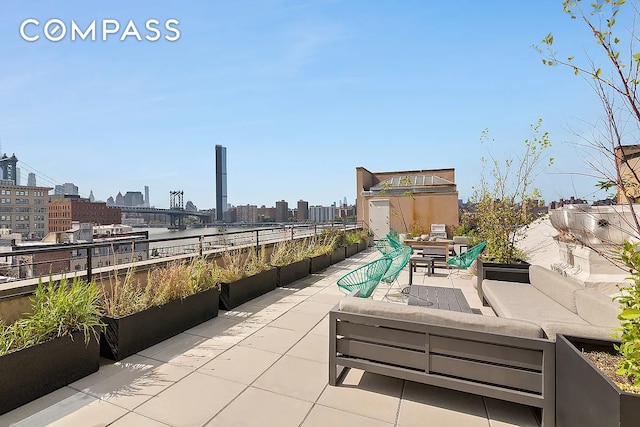 view of patio with an outdoor hangout area, a city view, and outdoor dining area