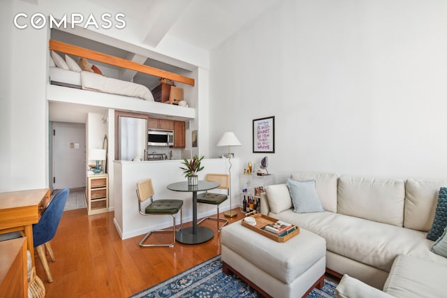 living area with wood finished floors and baseboards