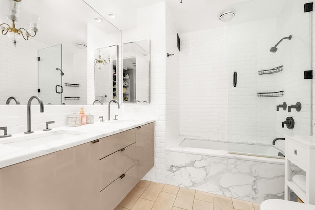 211 Madison Ave Unit 5B, New York City, NY 10016 - bathroom with double vanity, tiled shower / bath, tile patterned floors, and a chandelier
