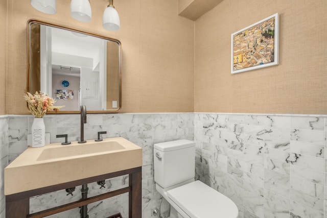 211 Madison Ave Unit 5B, New York City, NY 10016 - half bath with tile walls, vanity, and wainscoting
