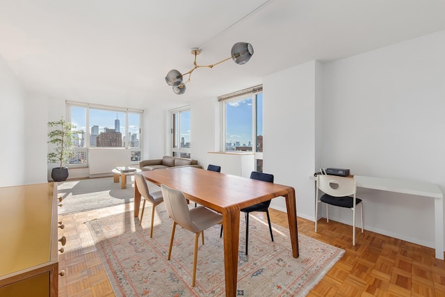 dining room with a city view and baseboards