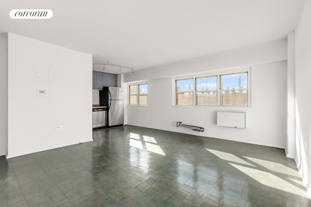 unfurnished living room with track lighting