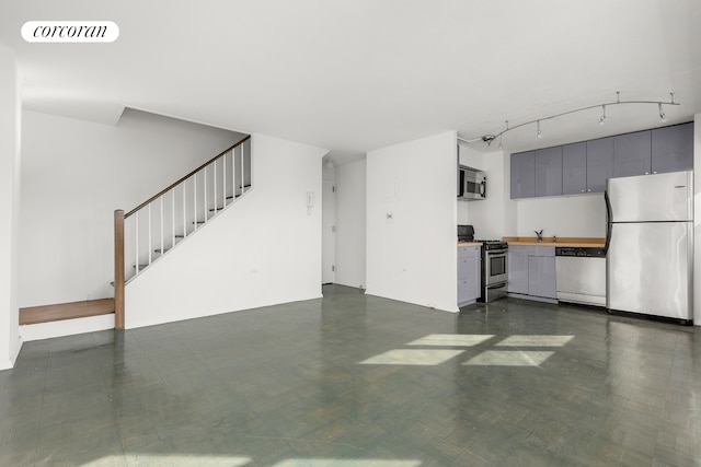unfurnished living room with stairway and a sink
