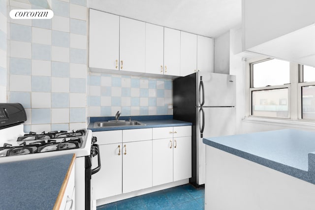 609 Columbus Ave Unit 4F, New York City, NY 10024 - kitchen featuring range with gas stovetop, a sink, freestanding refrigerator, and decorative backsplash