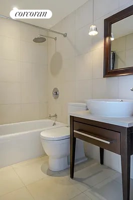 340 E 23rd St Unit Ph3D, New York City, NY 10010 - full bathroom with shower / tub combination, vanity, tile patterned flooring, and tile walls