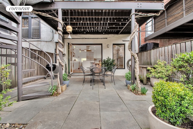 surrounding community with a patio, fence, and outdoor dining space
